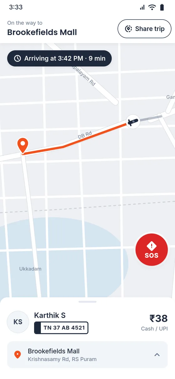 Tamil Taxi rider app during a ride: the driver on the map with share and SOS buttons